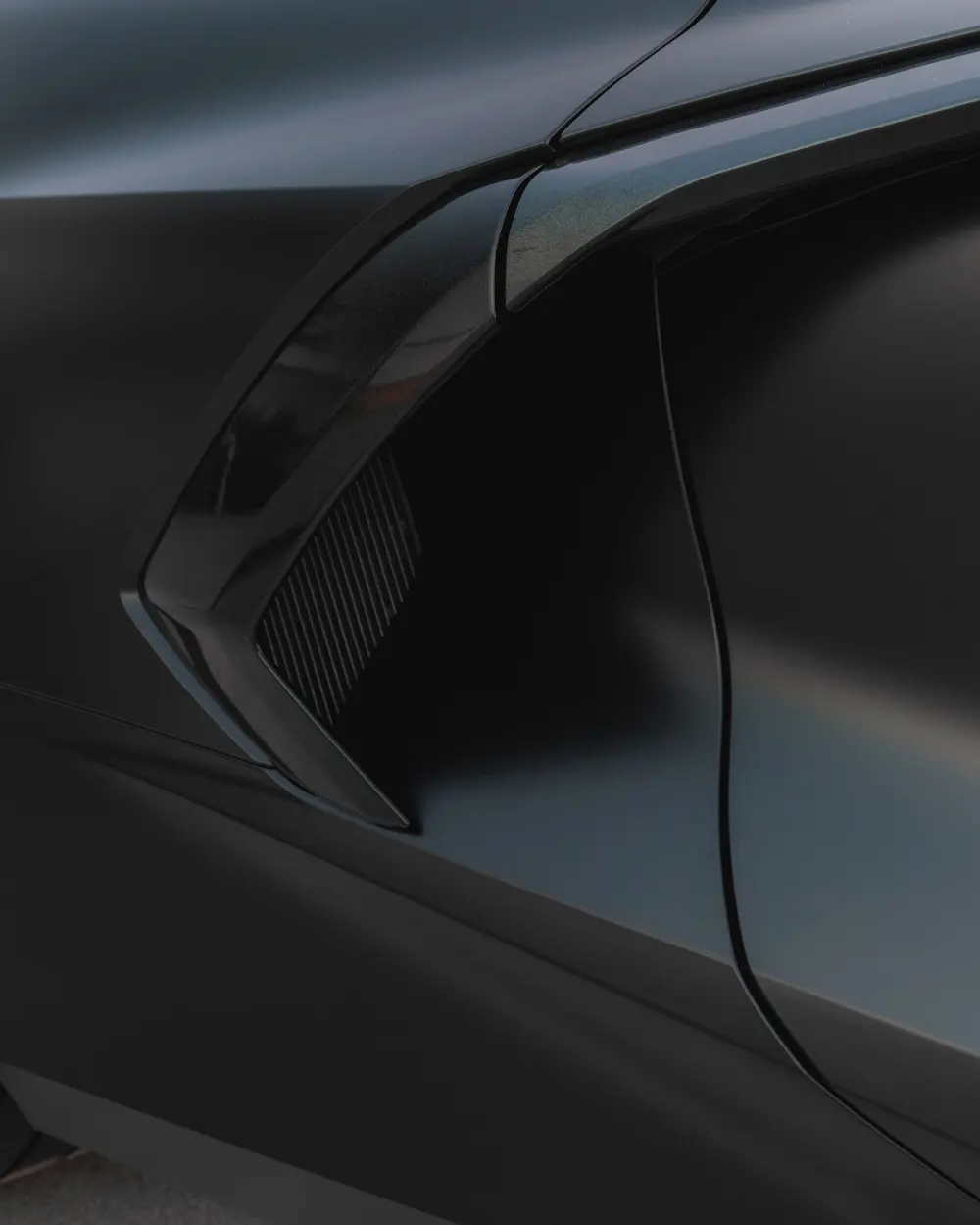 Black Corvette side vent detail after stealth finish work