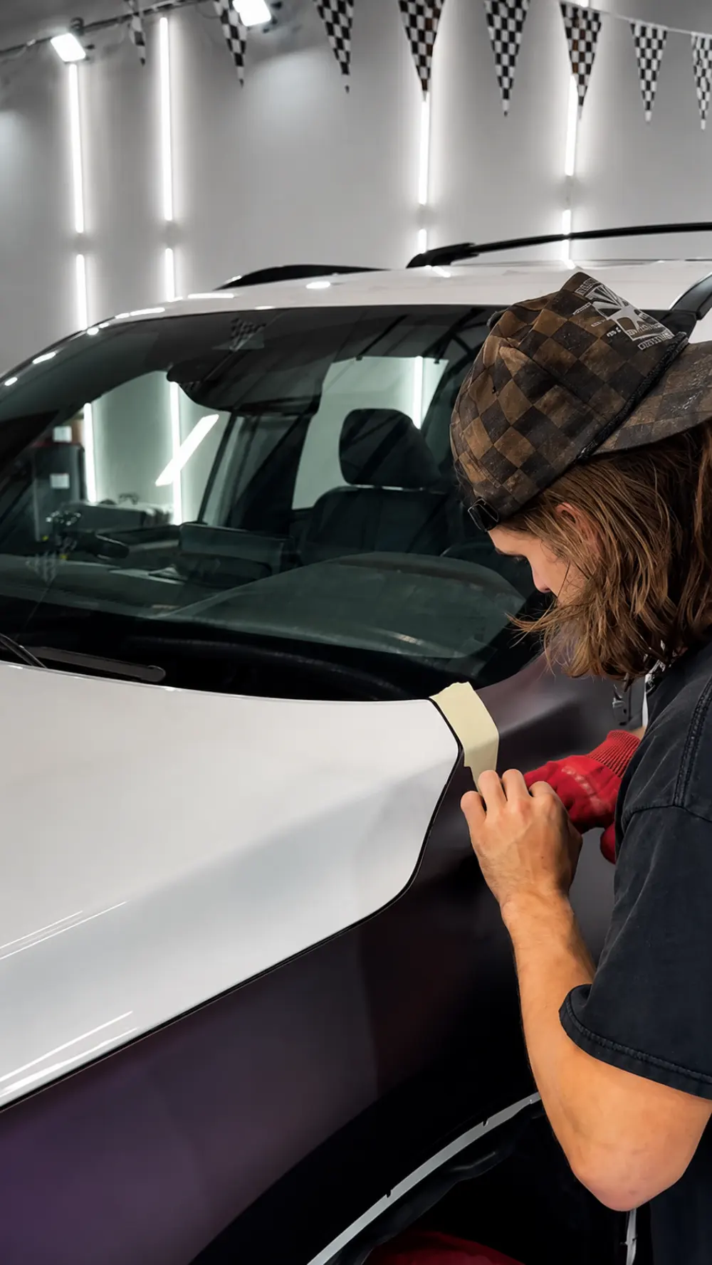Kelton installing side film on a Tesla project